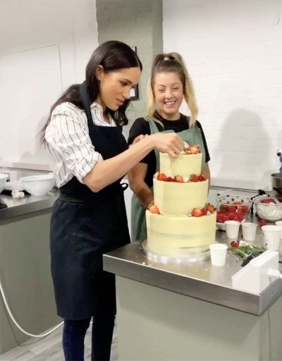 Meghan Markle decorating a cake at Luminary Bakery